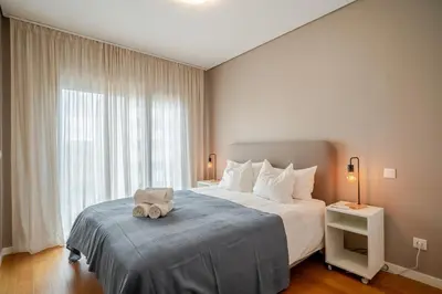a bedroom with a bed with a stuffed animal on it at HolidaysPT - Sunset At Lux Terrace - 2 Bedroom Apt in Faro