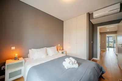 a bedroom with a large bed with towels on it at HolidaysPT - Sunset At Lux Terrace - 2 Bedroom Apt in Faro