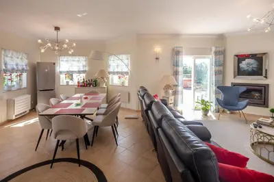 a living room with a table and a dining room at Amazing villa in Albufeira - Alke Vida in Albufeira