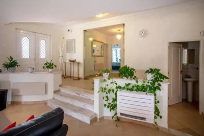 a living room with stairs and a plant at Amazing villa in Albufeira - Alke Vida in Albufeira