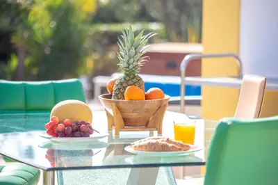 a glass table with a bowl of fruit on it at Amazing villa in Albufeira - Alke Vida in Albufeira