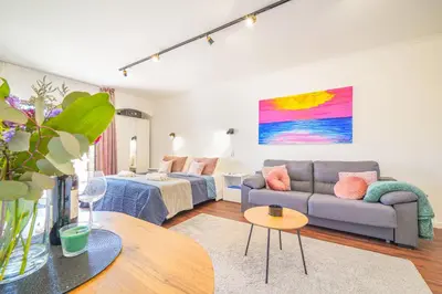 a living room with a couch and a table at Romantic Studio by Moje Holiday in Albufeira