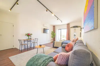 a living room with a couch and a table at Romantic Studio by Moje Holiday in Albufeira