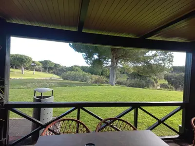 a screened in porch with a view of a field at Apartment with 2 bedrooms in Balaia, Olhos de Água, Albufeira in Albufeira