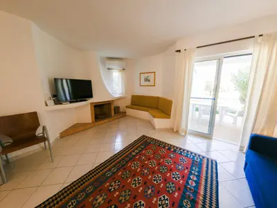a living room with a couch and a television at Apartment with 2 bedrooms in Balaia, Olhos de Água, Albufeira in Albufeira