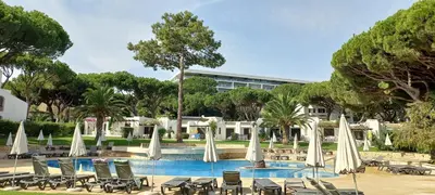 a resort with a pool with chairs and umbrellas at Apartment with 2 bedrooms in Balaia, Olhos de Água, Albufeira in Albufeira