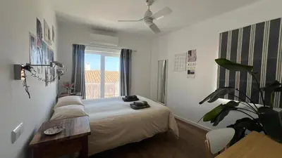 a bedroom with a bed and a ceiling fan at The Lemon Tree House by IntiHolidays in Boliqueime