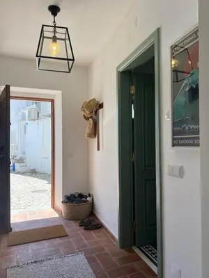 a hallway with a green door and a basket at The Lemon Tree House by IntiHolidays in Boliqueime