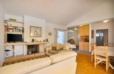 a living room with a couch and a fireplace at Your villa in Vilamoura in Quarteira