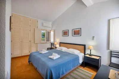 a bedroom with a blue bed with two towels on it at Your villa in Vilamoura in Quarteira