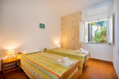 two beds in a room with a window at Your villa in Vilamoura in Quarteira