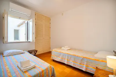 a bedroom with two beds and a window at Your villa in Vilamoura in Quarteira