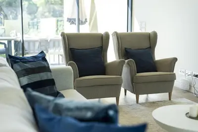 a living room with two chairs and a table with pillows at Vilamoura Parque - Luxury Villa with pool by HD in Vilamoura