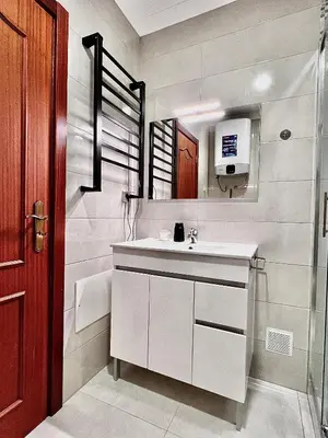a bathroom with a white sink and a mirror at OMG Faro in Faro