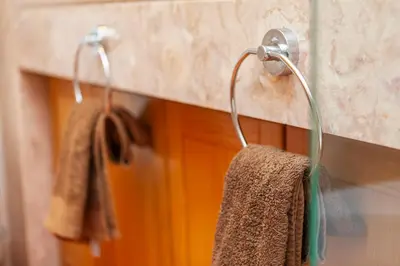 two towels hanging on a towel rack in a bathroom at Vila Sol F5 Vilamoura 2BR by Enjoy your stay in Quarteira