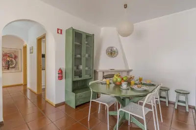 a dining room with a green table and chairs at #348 Apartment Madaleno by Home Holidays in Roja- Pé