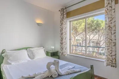 a bedroom with a bed with a pelican statue on it at #348 Apartment Madaleno by Home Holidays in Roja- Pé