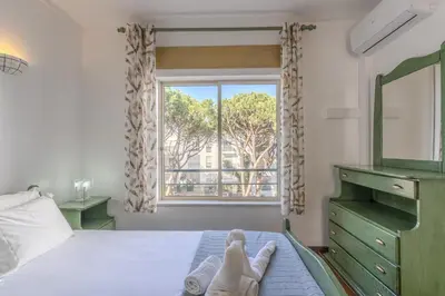 a bedroom with a bed with two pairs of shoes on it at #348 Apartment Madaleno by Home Holidays in Roja- Pé
