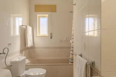 a bathroom with a tub and a toilet and a sink at #348 Apartment Madaleno by Home Holidays in Roja- Pé