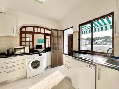 a kitchen with a washer and dryer at Vilamoura Brightness Apartment with Pool by Homing in Vilamoura
