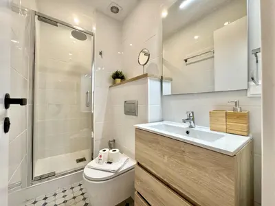 a bathroom with a toilet and a sink and a shower at Vilamoura Brightness Apartment with Pool by Homing in Vilamoura