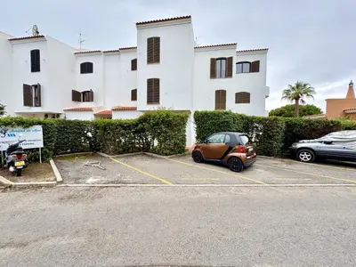 a small car parked in a parking lot in front of a building at Vilamoura Brightness Apartment with Pool by Homing in Vilamoura