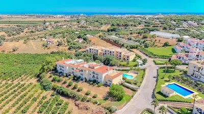 a large apartment building with a green yard at Bragança Paradise in Albufeira