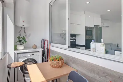 a bedroom with a bed and a wooden floor at Apartamento Machadinho in Albufeira