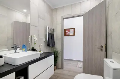 a bathroom with a shower and a toilet and a sink at Apartamento Machadinho in Albufeira