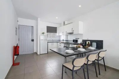 a kitchen with a table and chairs in it at Casa Machadinho in Albufeira