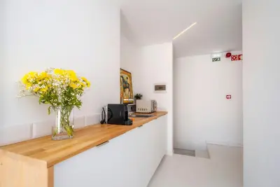 a bedroom with a bed and a television on a wall at Primavera House in Faro