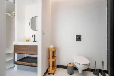 a room with a wall of black and silver tiles at Primavera House in Faro