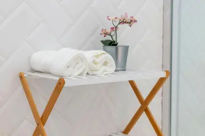 a vase of yellow flowers on a counter in a room at Primavera House in Faro