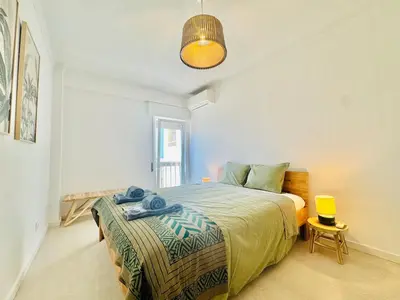 a bedroom with a bed and a pendant light at Doble Vista Faro, Terrace with View, AC & WiFi in Faro