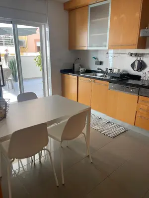 a kitchen with a white table and chairs in it at City Dreams in Faro