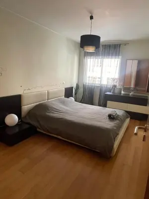 a bed in a room with a wooden floor at City Dreams in Faro