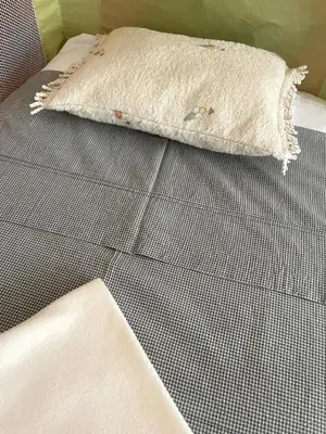 a white pillow sitting on top of a bed at City Dreams in Faro