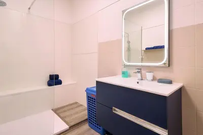 a bathroom with a sink and a mirror at Casa Sauchi mit Gemeinschaftspool - Neu renoviert in Albufeira