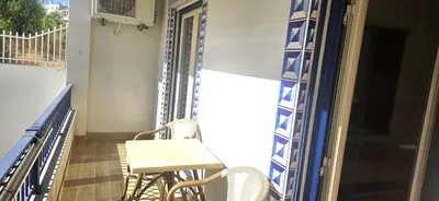 a balcony with a table and chairs on it at Ocean life in Albufeira