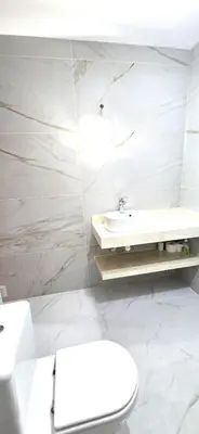 a bathroom with a white toilet and a sink at Ocean life in Albufeira