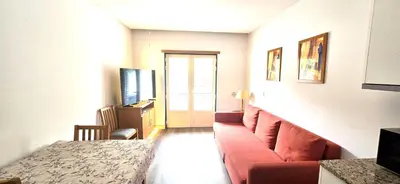 a living room with a couch and a television at Ocean life in Albufeira