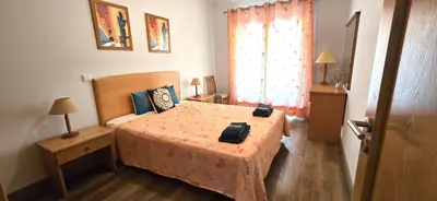 a bedroom with a bed with two bags on it at Ocean life in Albufeira
