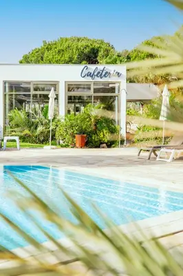 a hotel with a swimming pool in front of a building at Alfagar Prestige in Albufeira