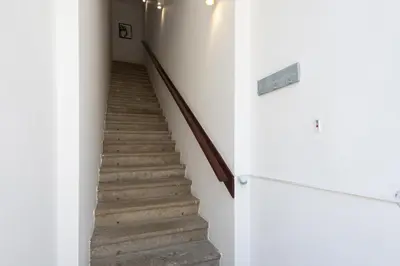 a staircase in a house with white walls and wooden floors at Marggisa - City Center by HD in Faro