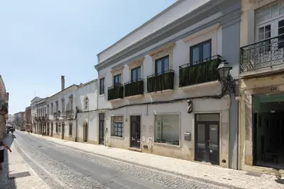 an empty street in a city with buildings at Marggisa - City Center by HD in Faro