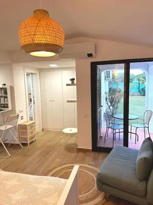 a living room with a couch and a table at Refúgio junto à falésia in Olhos de Água