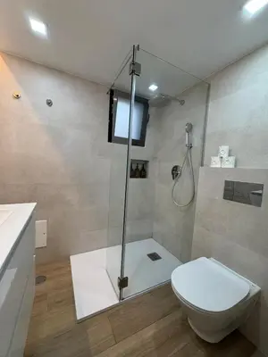 a bathroom with a shower with a toilet and a sink at Refúgio junto à falésia in Olhos de Água