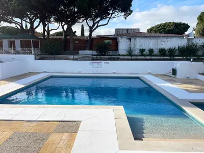 a swimming pool with blue water in a yard at Refúgio junto à falésia in Olhos de Água