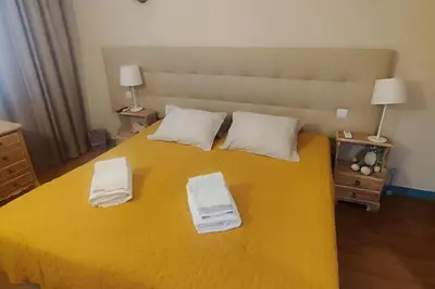 a yellow bed with two towels on top of it at Apartment - Sleeps 2 - Pool - Parking - Balcony in Albufeira