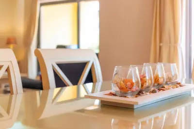 a table with two glasses and rocks on a plate at 3 Quartos, Piscina, AC, Garagem, Prestige For Home in Faro